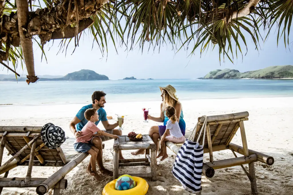 A family relaxing together in deck chairs at the beach