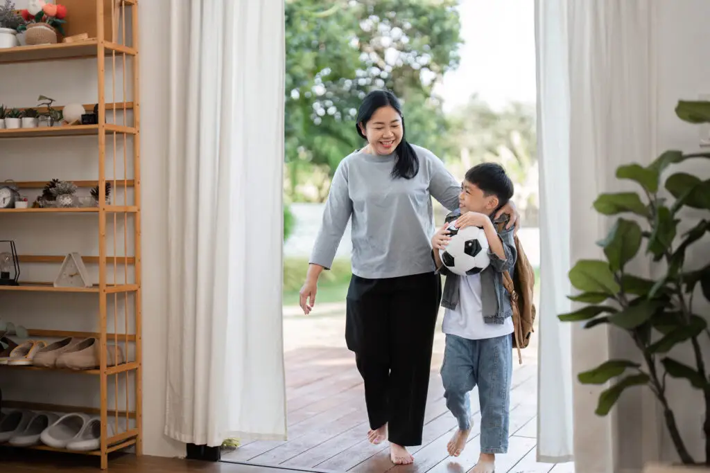 A mother and son heading out the door together for the school day